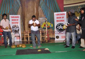 MOST NUMBER OF TENDER COCONUTS HUSKED WITH TEETH  